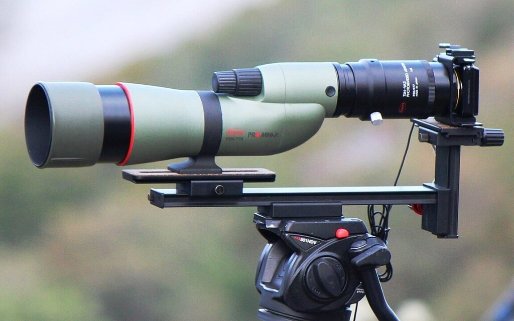 A digital camera attached to a spotting scope for digiscoping.