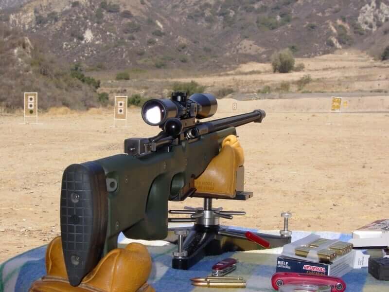 Spotting scope in use by sport shooters, mounted to gun (Image)